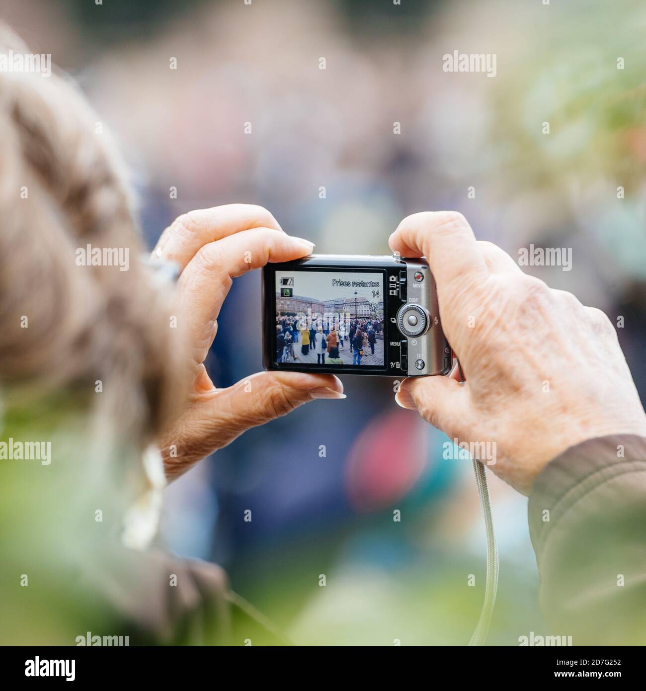 Strasbourg, France - Oct19, 2020: Square image senior taking photo of crowd after history teacher Samuel Paty, beheaded on Oct16th after showing caricatures of Prophet Muhammad in class Stock Photo