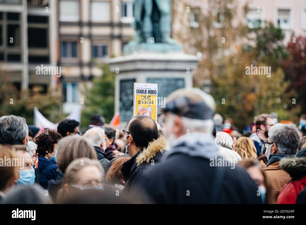 Strasbourg, France - Oct 19, 2020: Man holding Charlie Hebdo caricature Place Kleber to pay tribute to history teacher Samuel Paty, beheaded on Oct 16th after showing caricatures of Prophet Muhammad in class Stock Photo