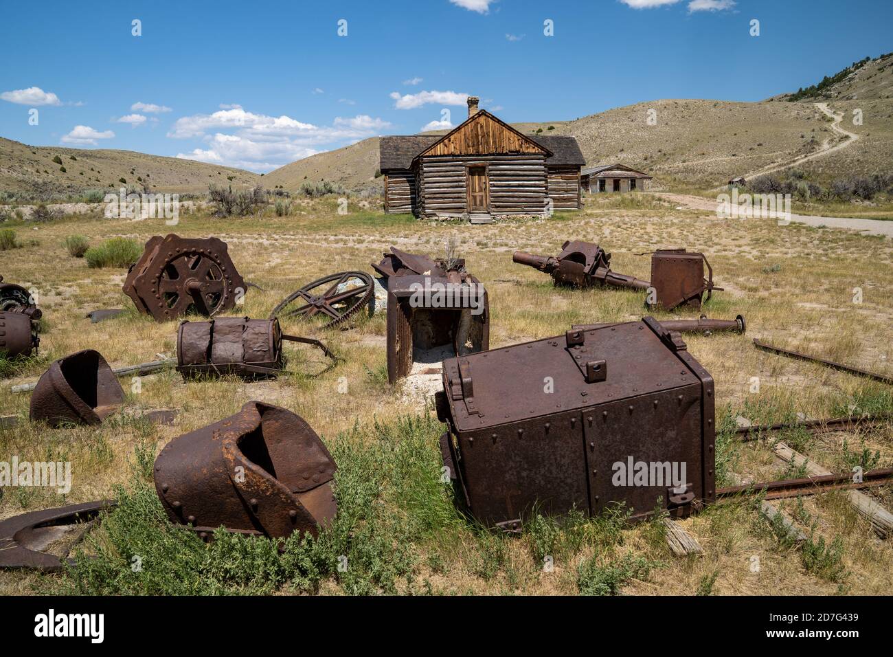 Old mining equipment, abandoned, rusting in the grass in Bannack Ghost Town in Montana Stock