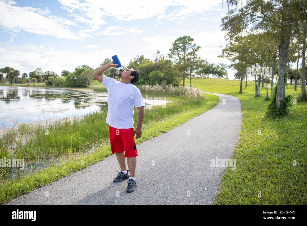 man stop to drink water after running Stock Photo Alamy