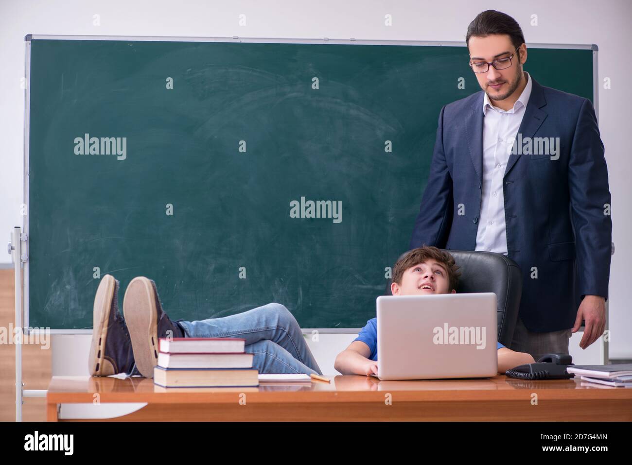 Male teacher and schoolboy in the classroom Stock Photo