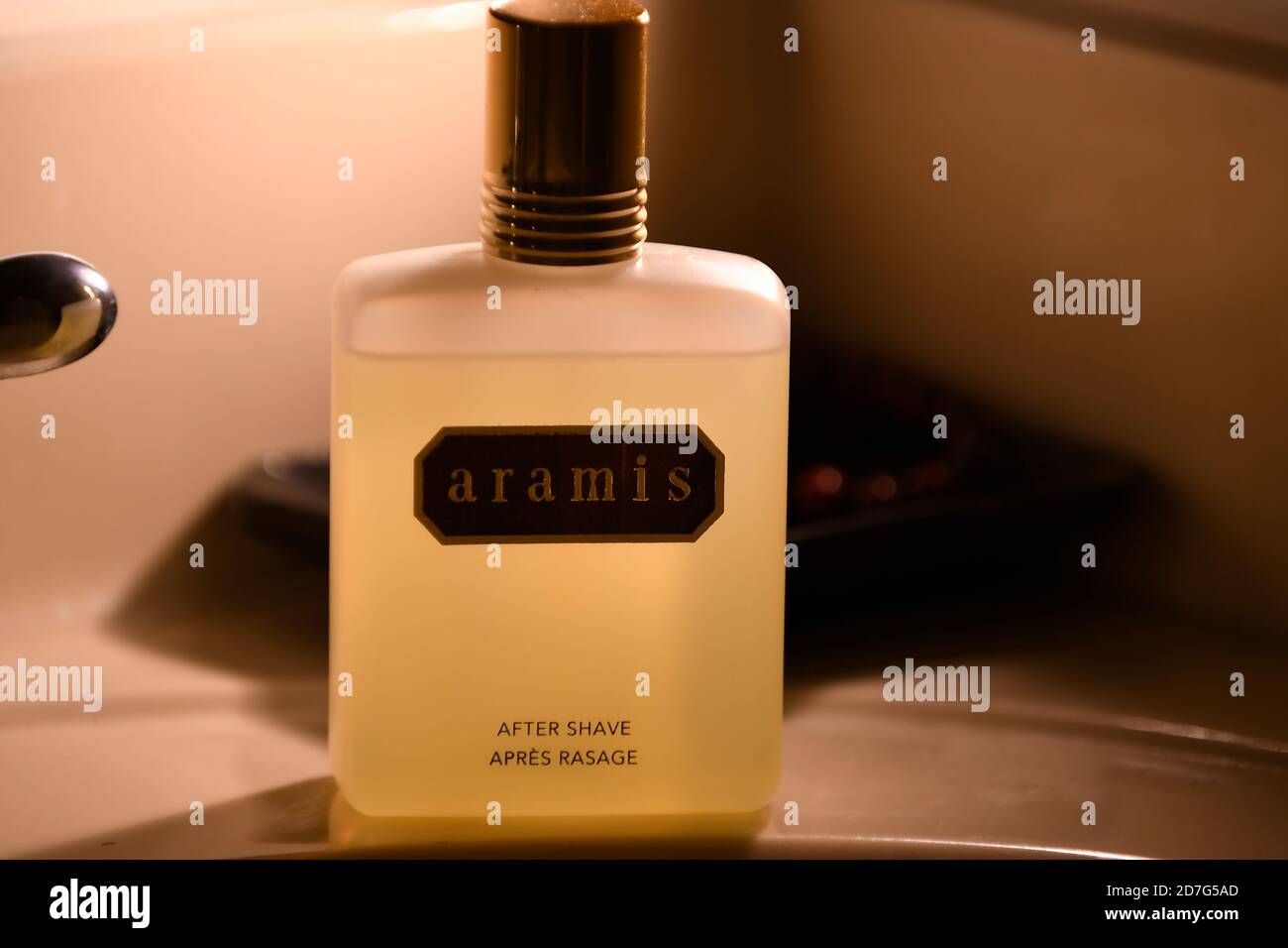 After Shave cologne on bathroom sink counter soap dish in background with  mood lighting Stock Photo - Alamy