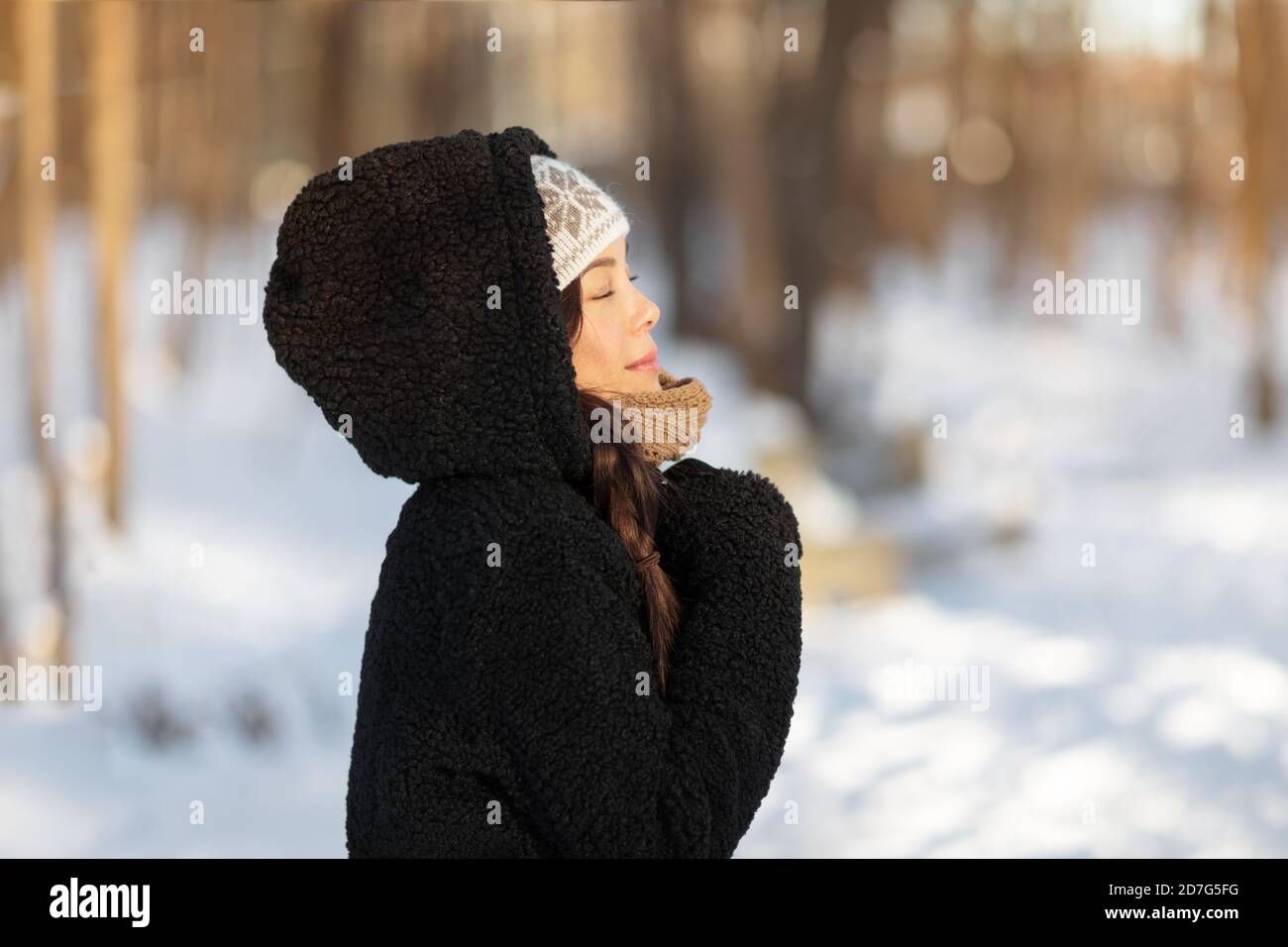 Winter happy woman relaxing breathing cold air outside young people