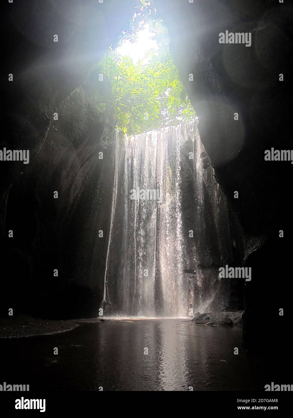 A beautiful waterfall inside a cave in Bali. Stock Photo