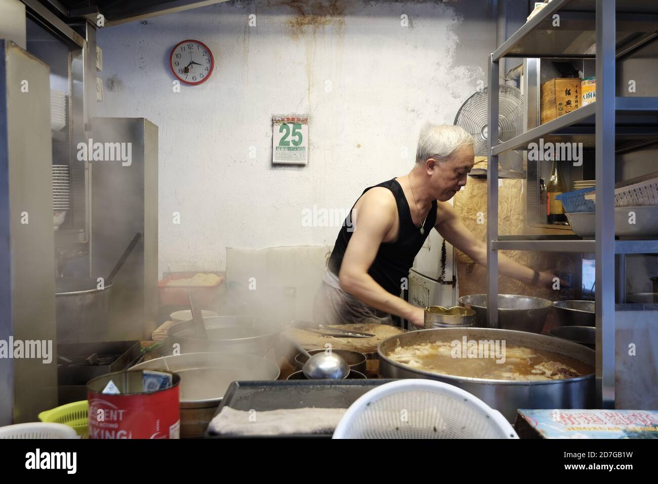 Old man working in a kitchen Stock Photo