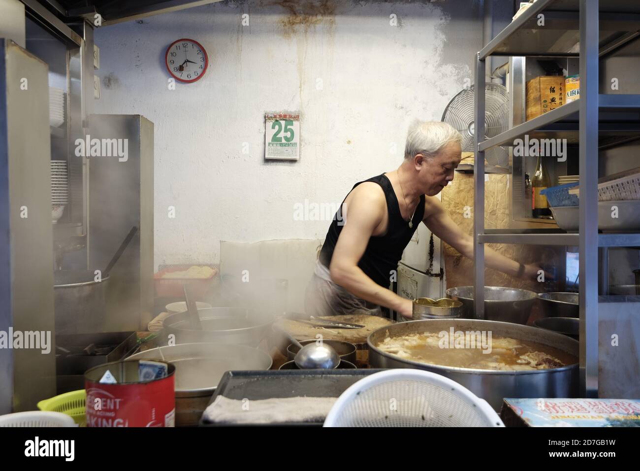 Man wearing apron cooking hi-res stock photography and images - Alamy