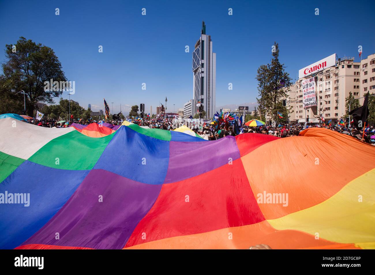 SANTIAGO, CHILE-OCTOBER 18, 2020 - Demonstrators wave a huge Wiphala flag during a protest at Plaza Italia in Santiago, Chile Stock Photo