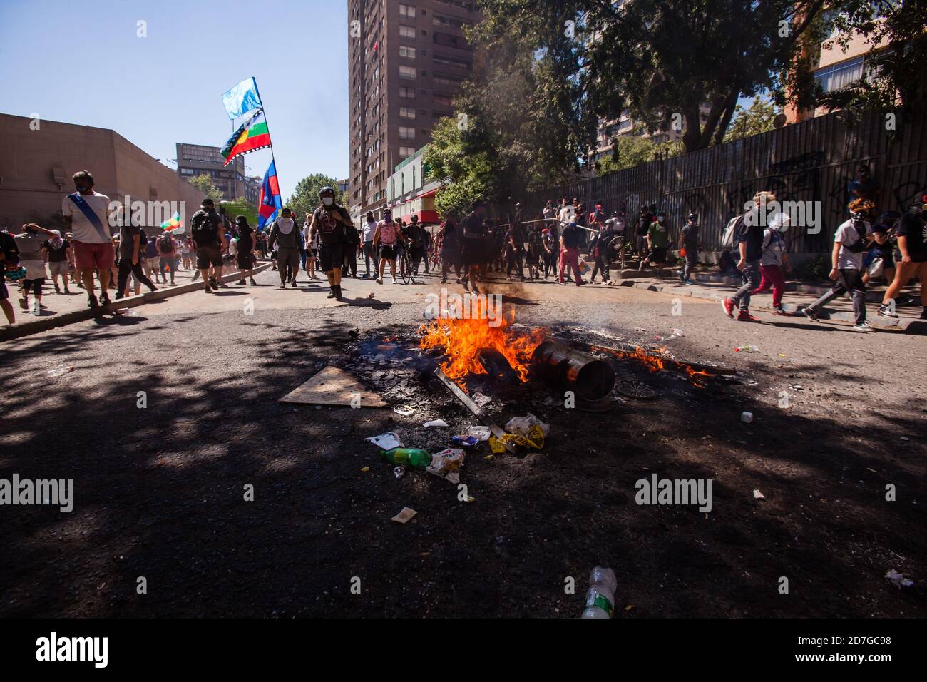 SANTIAGO, CHILE-OCTOBER 18, 2020 - Demonstrators walks near of a barricade during a protest at Plaza Dignidad (former Plaza Italia) in Santiago, one y Stock Photo