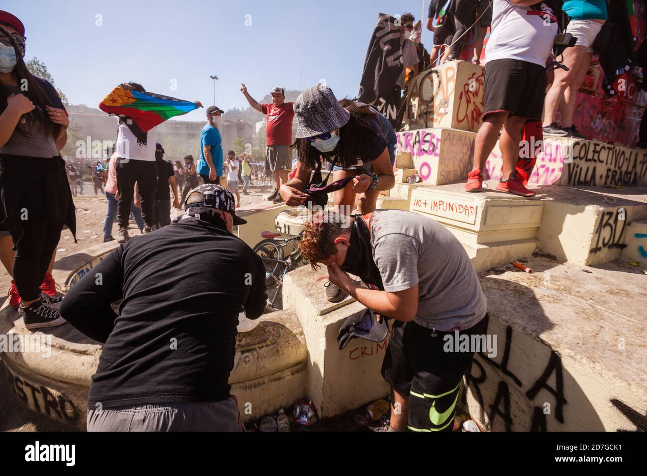 SANTIAGO, CHILE-OCTOBER 18, 2020 - violent clashes between teams of soccer hooligans while a peaceful demonstration is taking place in Plaza Italia Stock Photo