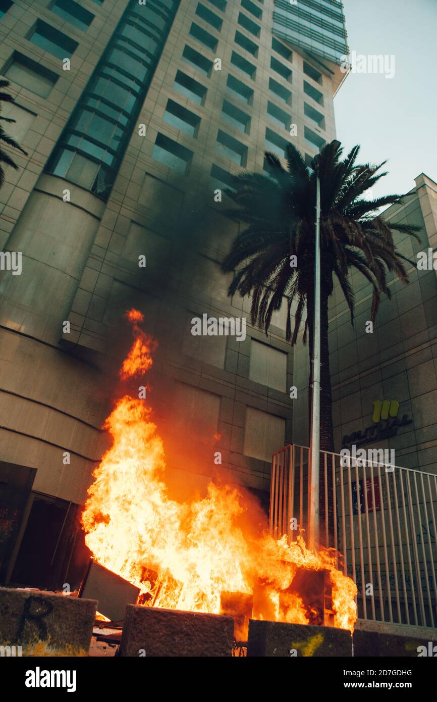 SANTIAGO, CHILE-OCTOBER 18, 2020 - People loot and burn a office building during a protest, one year after the social outbreak of October 18. Stock Photo