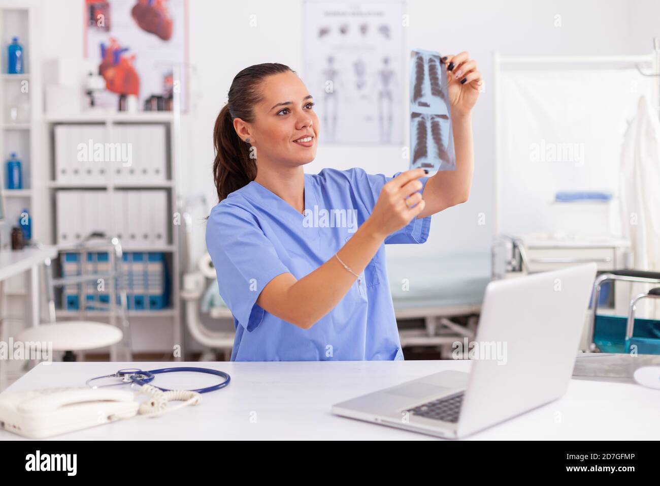 Medical nurse holding patient radiography in hospital office ...
