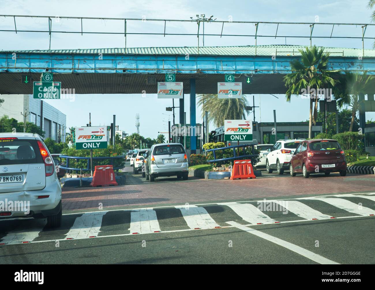 Cars waiting in line at the famous Uthandi Toll Plaza located on the scenic East Coast Road highway. Stock Photo