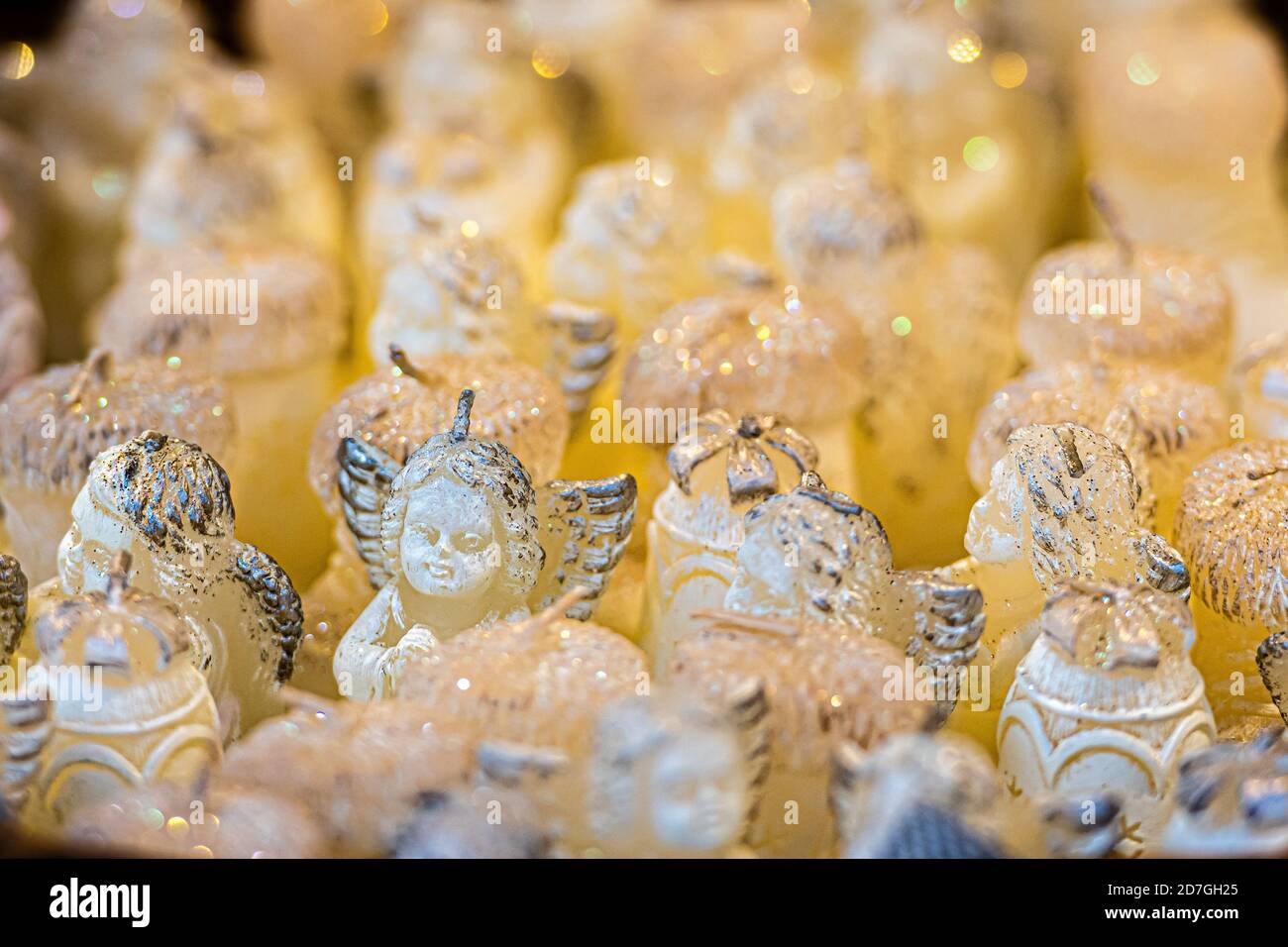 basket with white angelshaped candles at the Christmas market, close