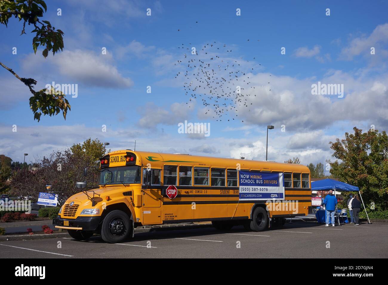 A school bus driver recruitment booth is seen in a parking lot in Tigard, Oregon, on Wednesday, October 21, 2020, amid the coronavirus pandemic. Stock Photo