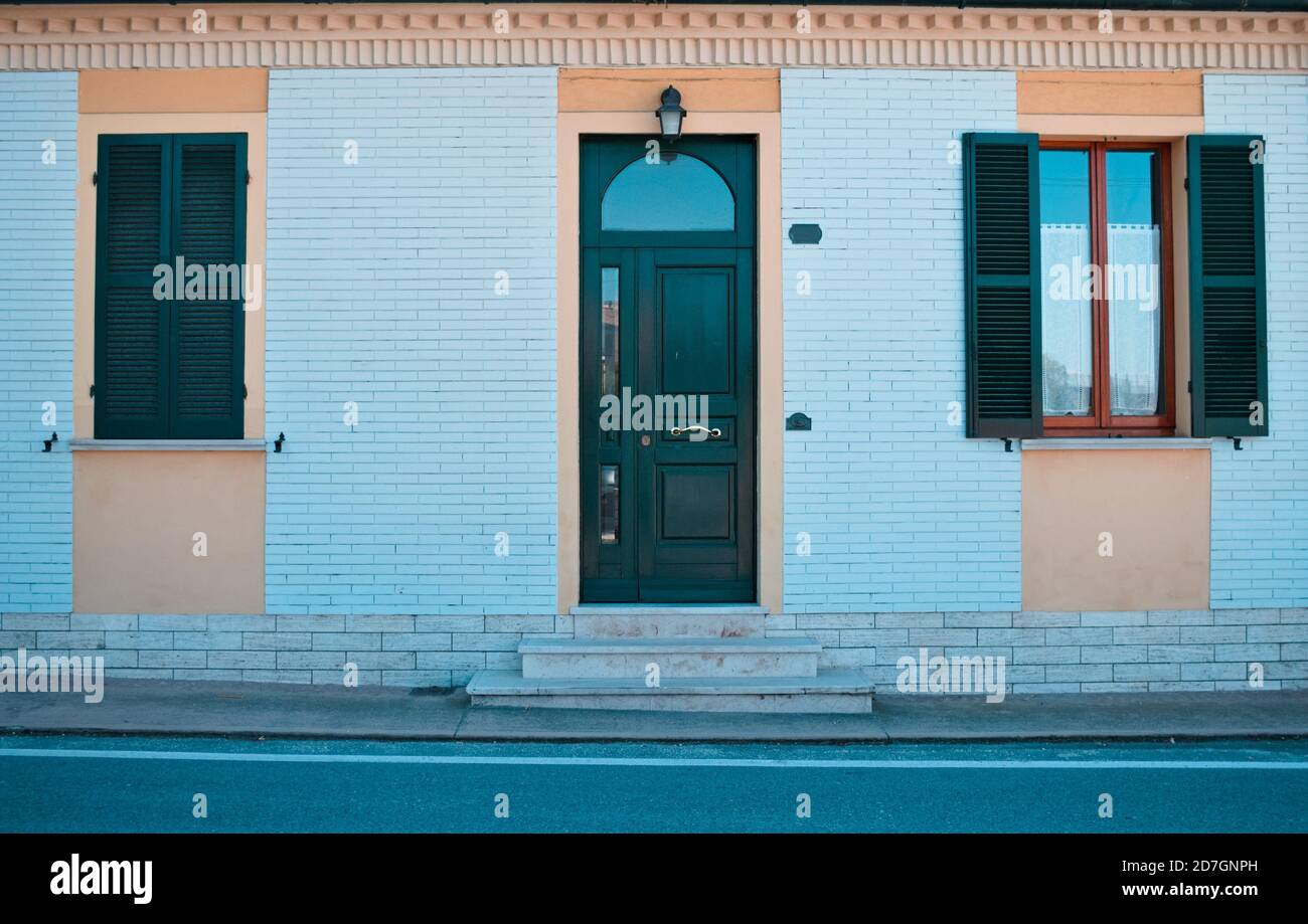 Vintage facade of an italian building with a white brick wall (Pesaro