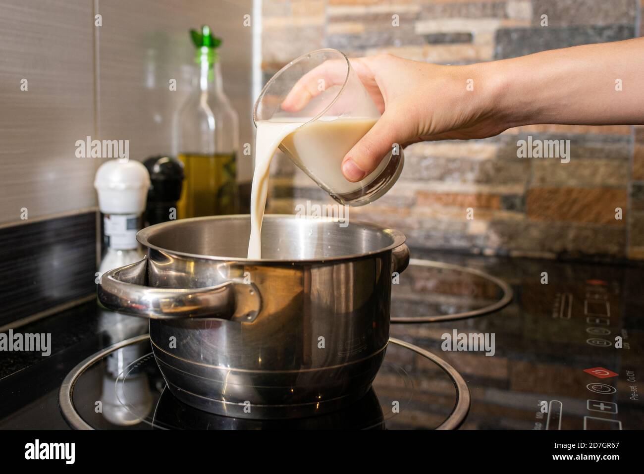 https://c8.alamy.com/comp/2D7GR67/closeup-of-a-person-making-oatmeal-with-milk-in-a-pot-on-the-stove-2D7GR67.jpg
