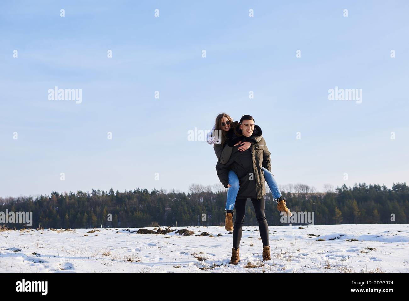 happy couple hugging and laughing outdoors in winter Stock Photo - Alamy