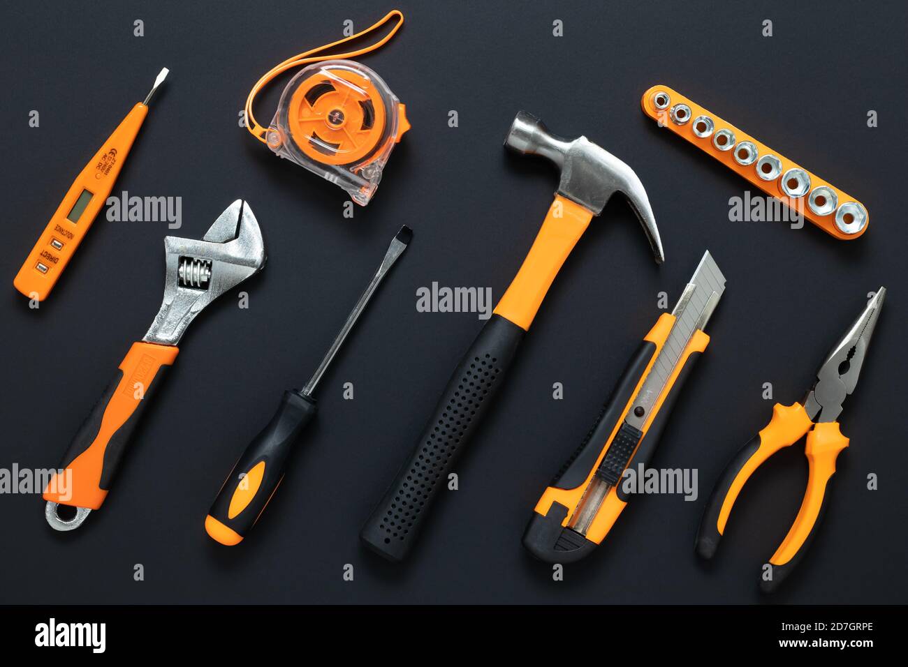 Set of tools on black background. Construction, DIY concept. Equipment,  workplace. Flat lay composition. Screwdriver, tape measure, wrench, knife, ha Stock Photo