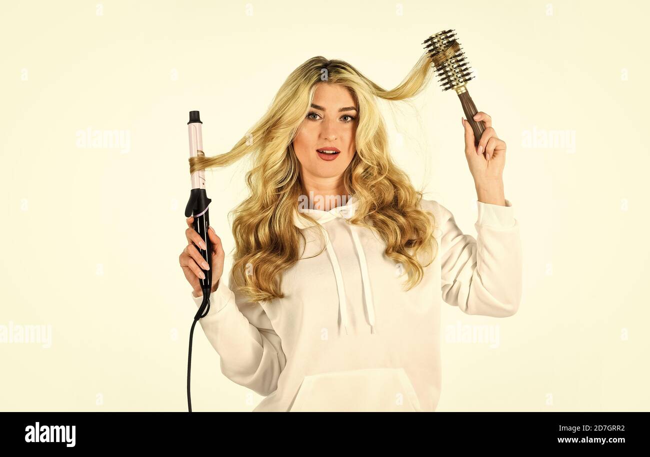 Using different wrapping techniques. Choose right type curling iron for your needs. Girl adorable blonde. Online shop. Create hairstyle. Woman with long curly hair use curling iron. Hairdresser tips Stock Photo - Using different wrapping techniques. Choose right type curling iron for your needs. Girl adorable blonde. Online shop. Create hairstyle. Woman with long curly hair use curling iron. Hairdresser tips Stock Photo -