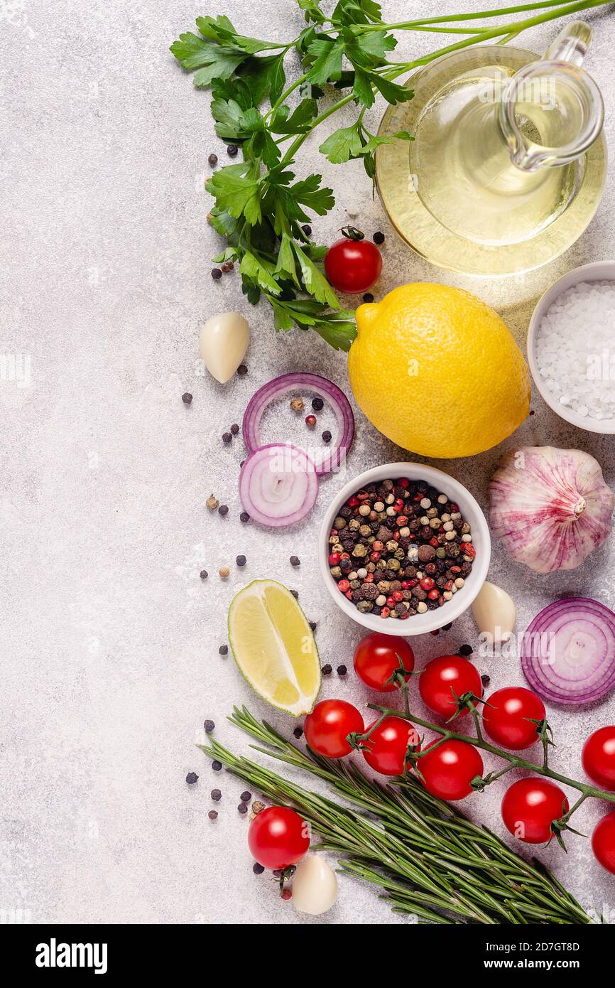 Herbs and condiments on light stone background. Top view with copy ...