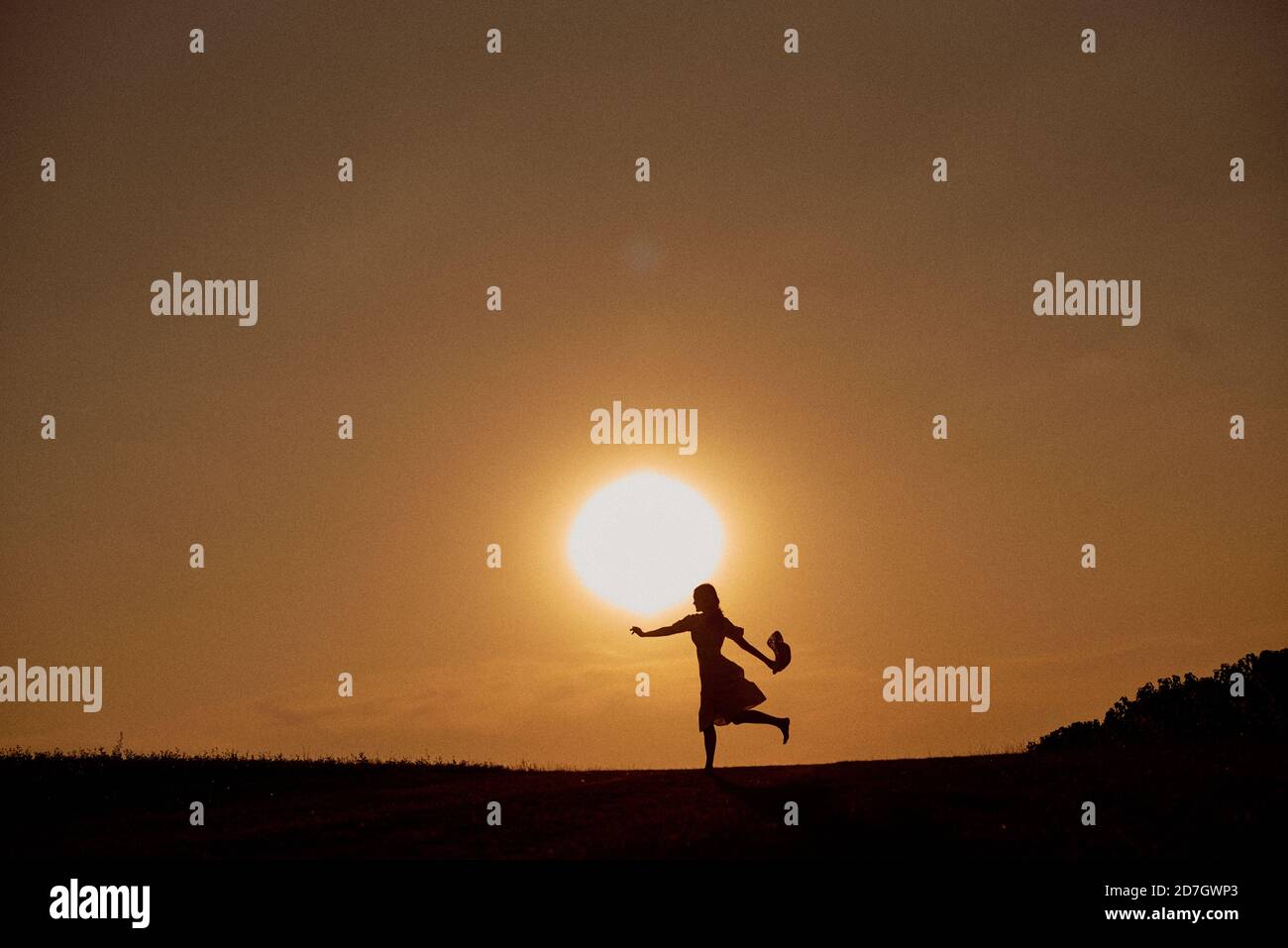 Silhouette of a girl running across the field Stock Photo - Alamy