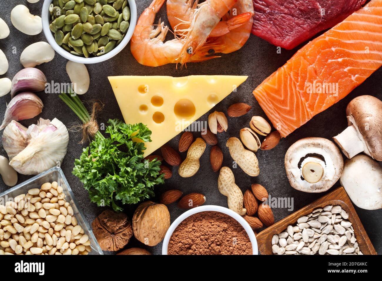 Foods High in Zinc as salmon, seafood-shrimps, beef, yellow cheese, parsley leaves, mushrooms, cocoa, pumpkin seeds, garlic, bean, almonds, pine nut. Stock Photo