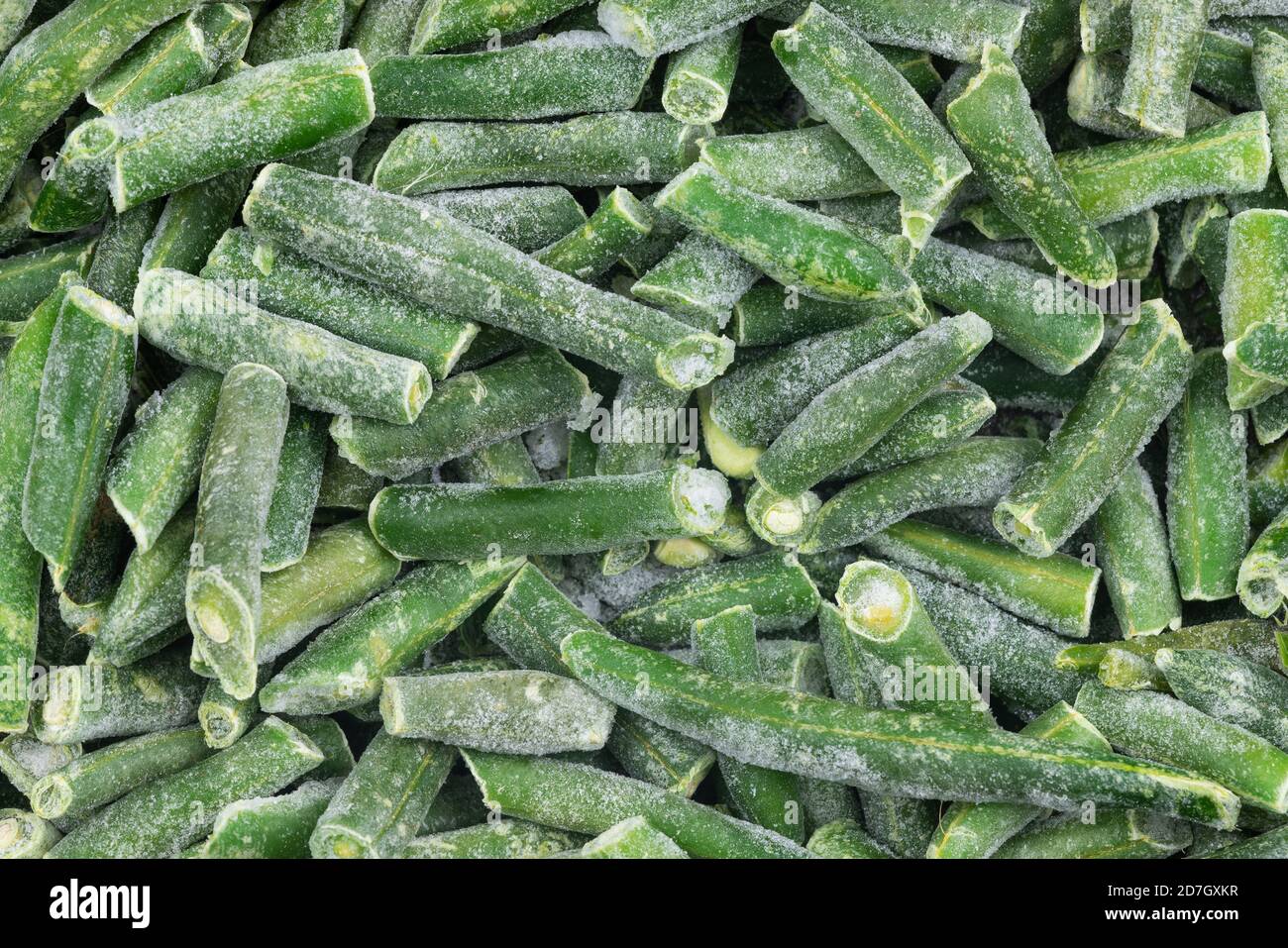Frozen chopped green string beans texture background. iced beans