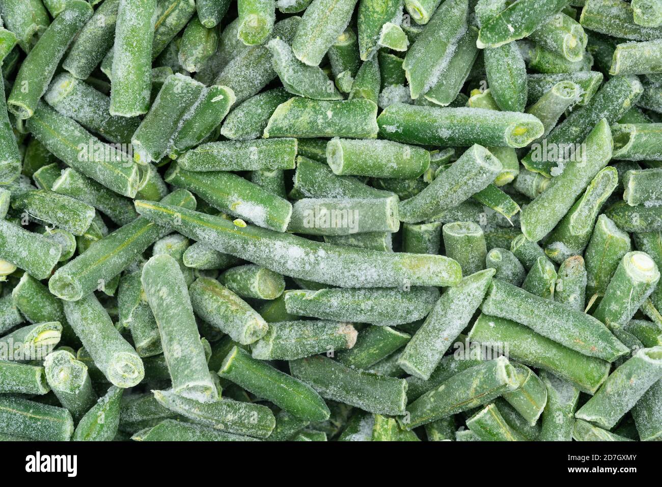 Frozen chopped green string beans texture background. iced beans
