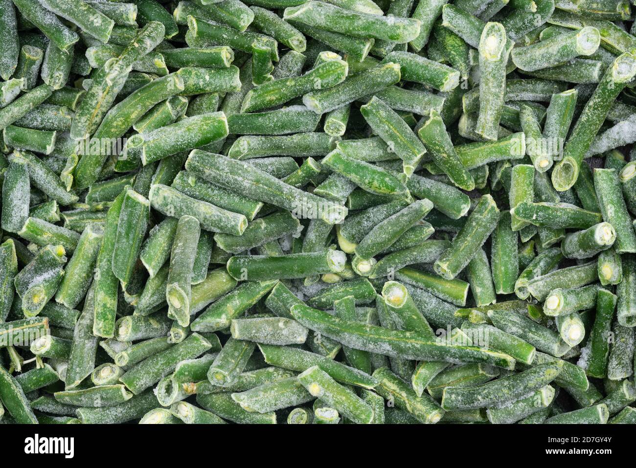 Frozen chopped green string beans texture background. iced beans