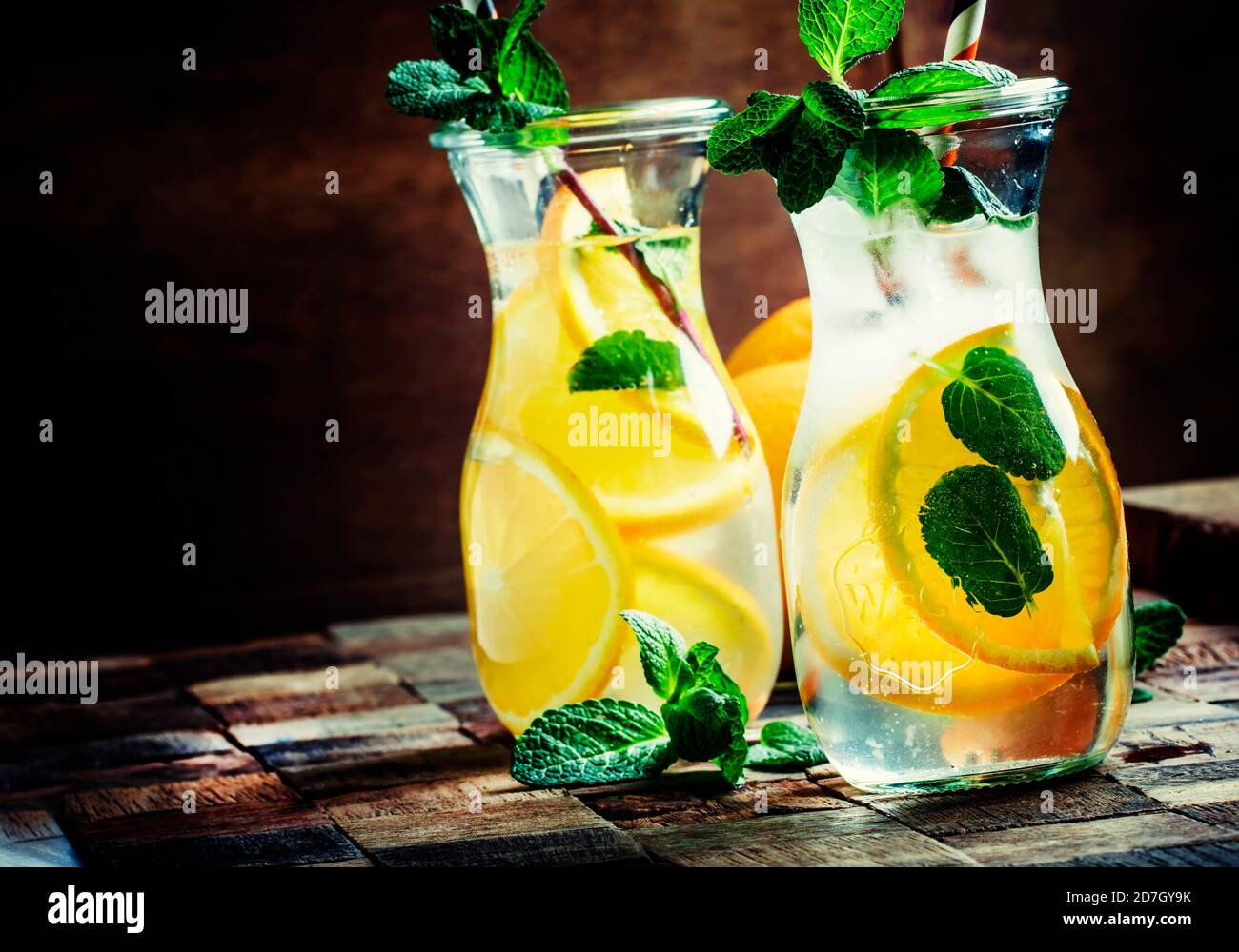 Mojito and Lemonade summer cold drink in a plastic glass with a straw.  Coctail with mint, lemon, lime and ice. Serve at the bar. Beverage closeup  Stock Photo - Alamy