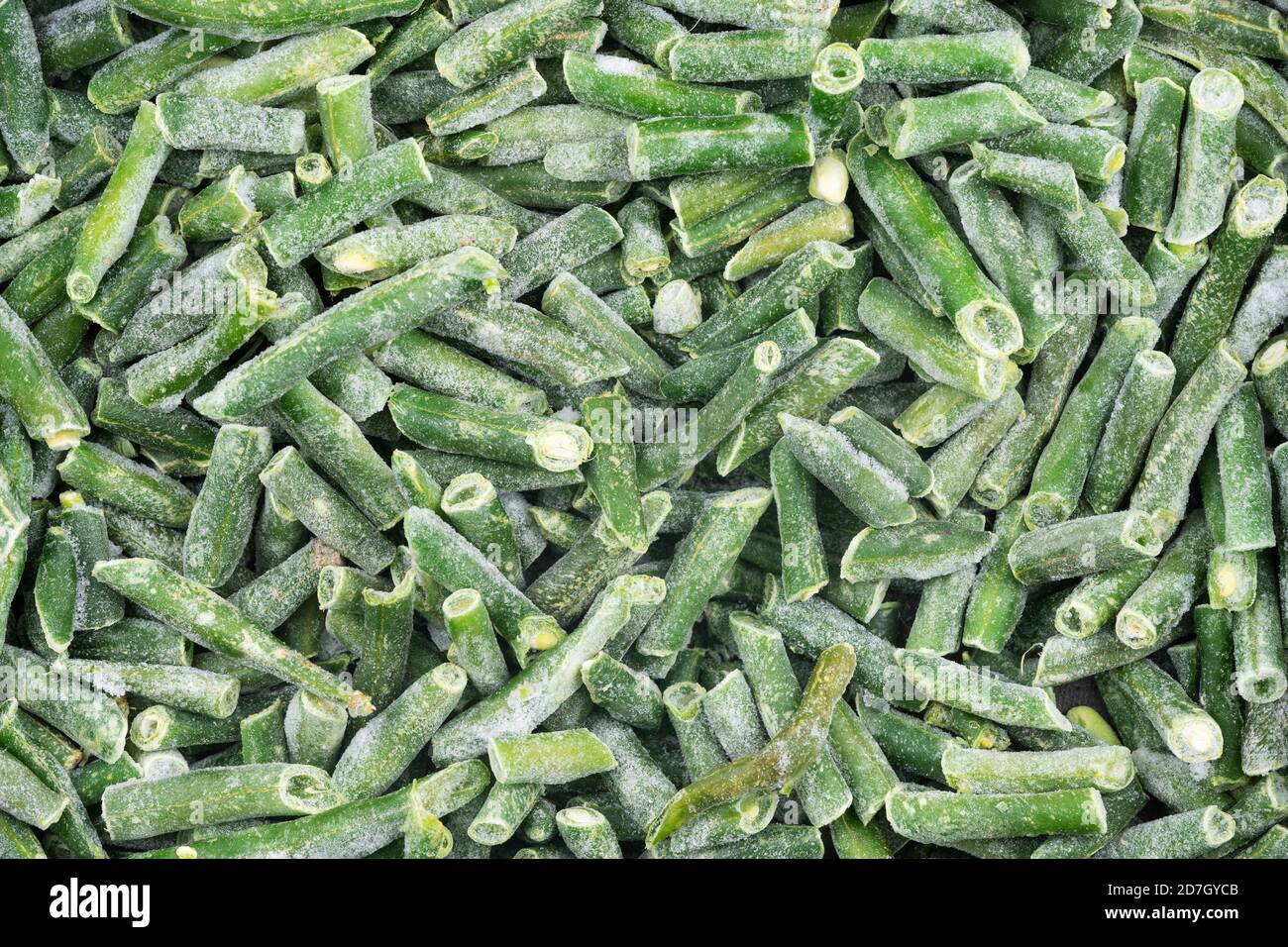 Frozen chopped green string beans texture background. iced beans