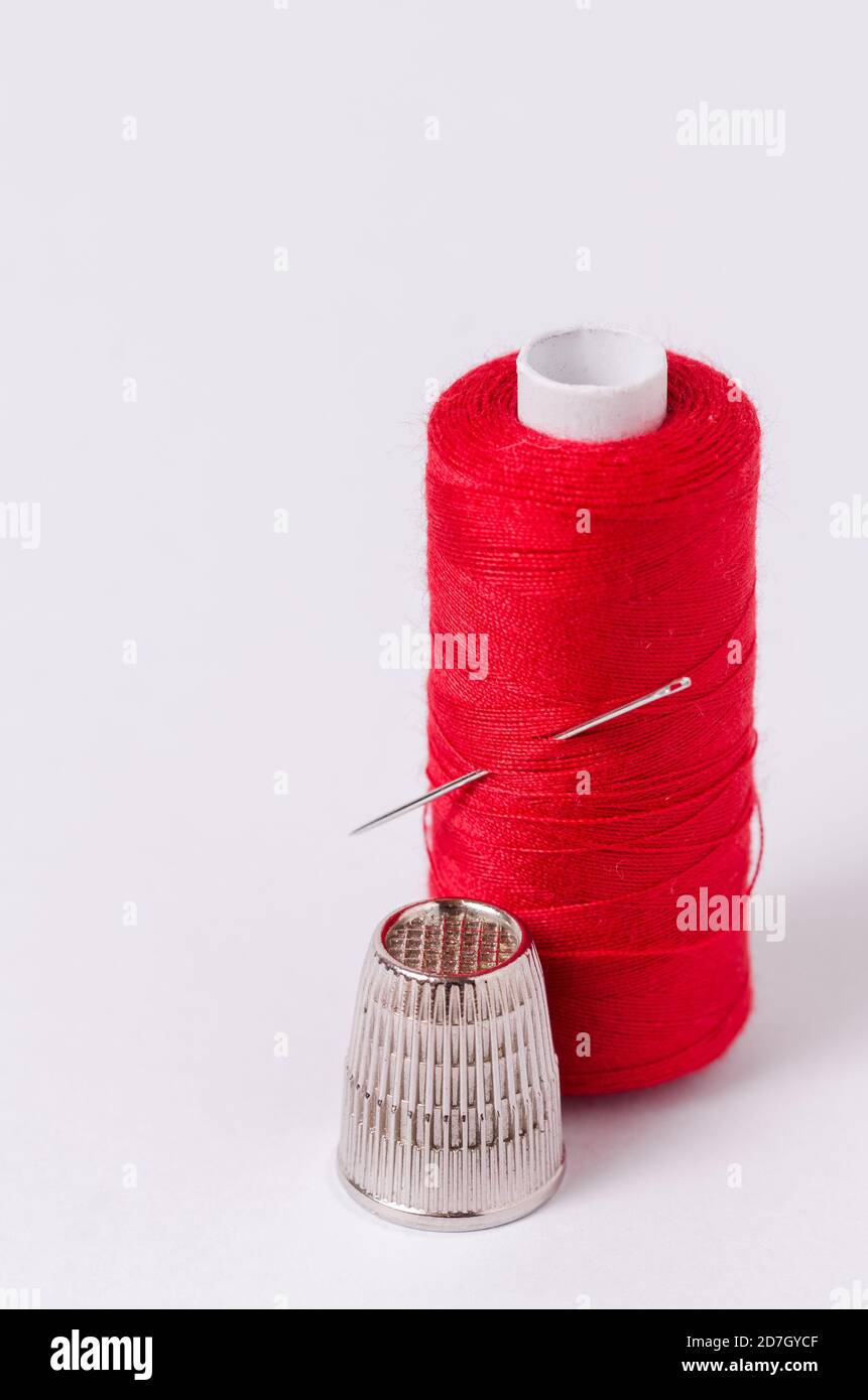 A Needle Stuck In A Spool Of Thread Stock Photo - Download Image