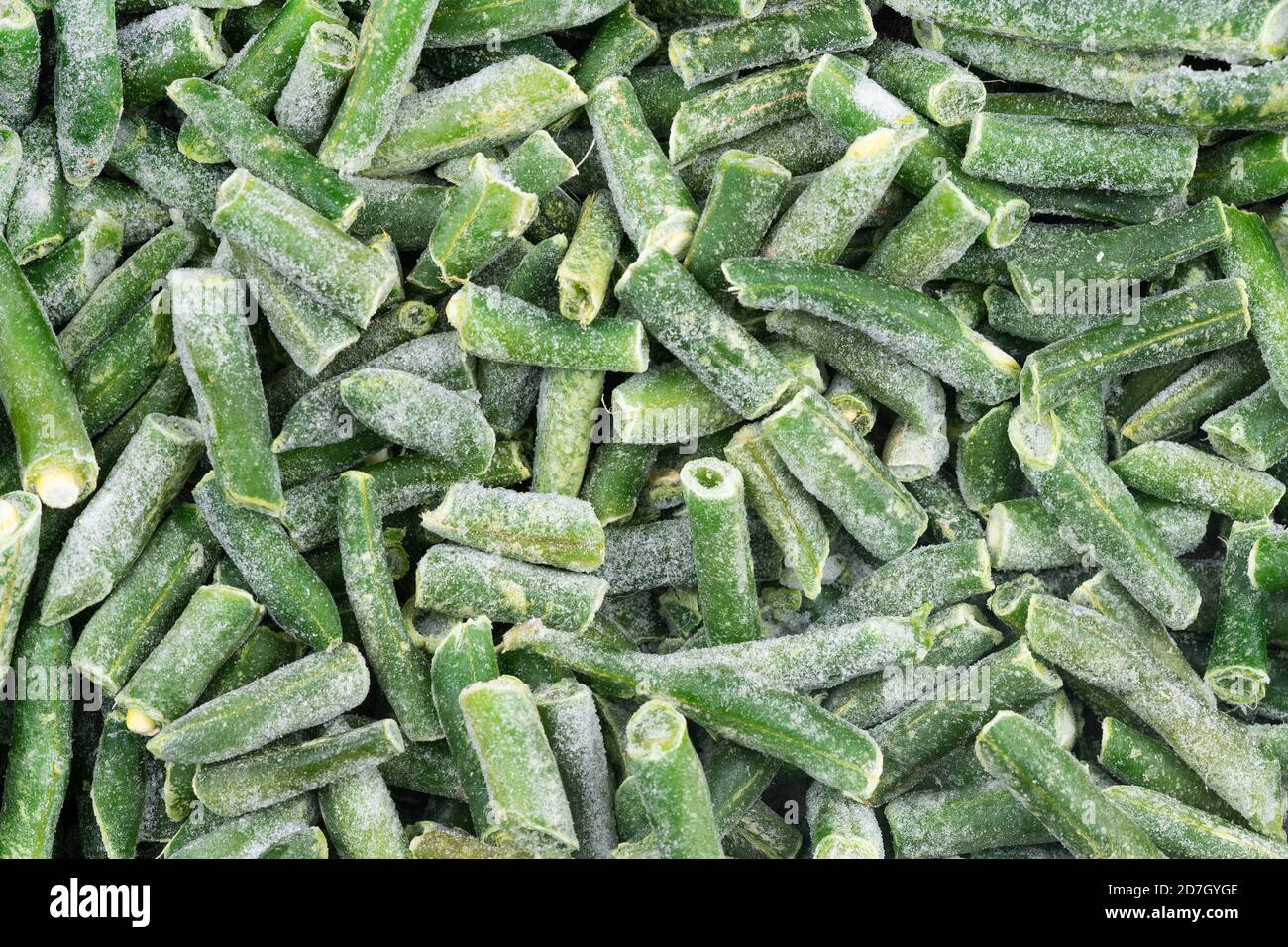 Frozen chopped green string beans texture background. iced beans