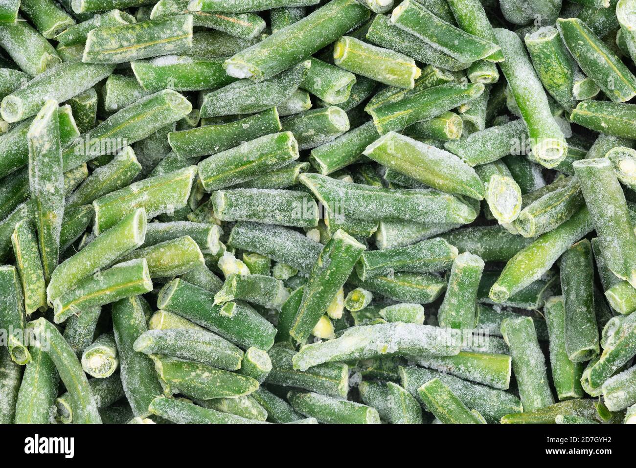 Frozen chopped green string beans texture background. iced beans
