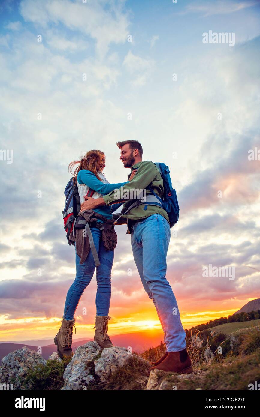Couple on Top of a Mountain Hugging and enjoying view Stock Photo - Alamy