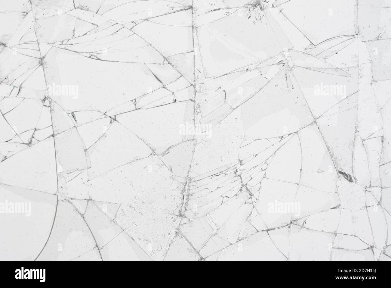 White cracked glass texture background. Texture broken glass window with cracks. Broken screen. Stock Photo