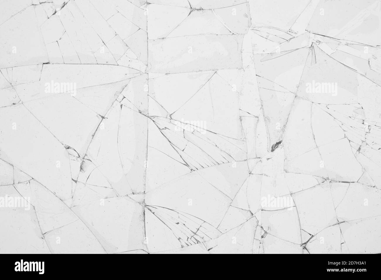 White cracked glass texture background. Texture broken glass window with cracks. Broken screen. Stock Photo