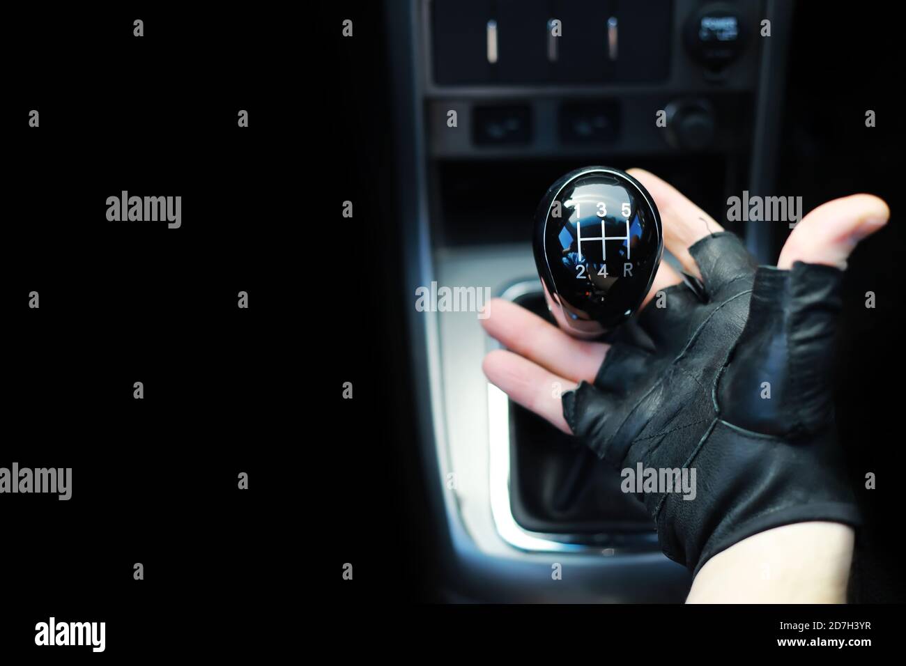 Gear lever. Manual Transmission. Hand on the gear shift in the car
