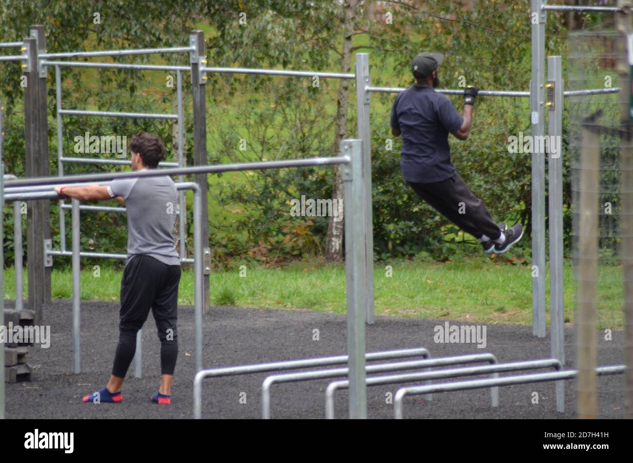 Black Fitness goers on railings Stock Photo - Alamy