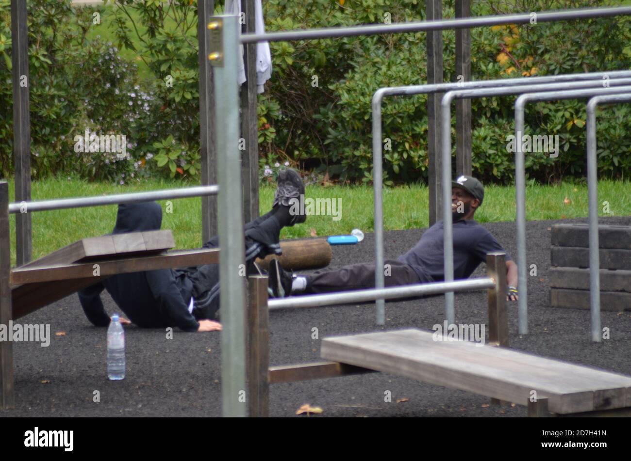 Black Fitness goers on railings Stock Photo - Alamy