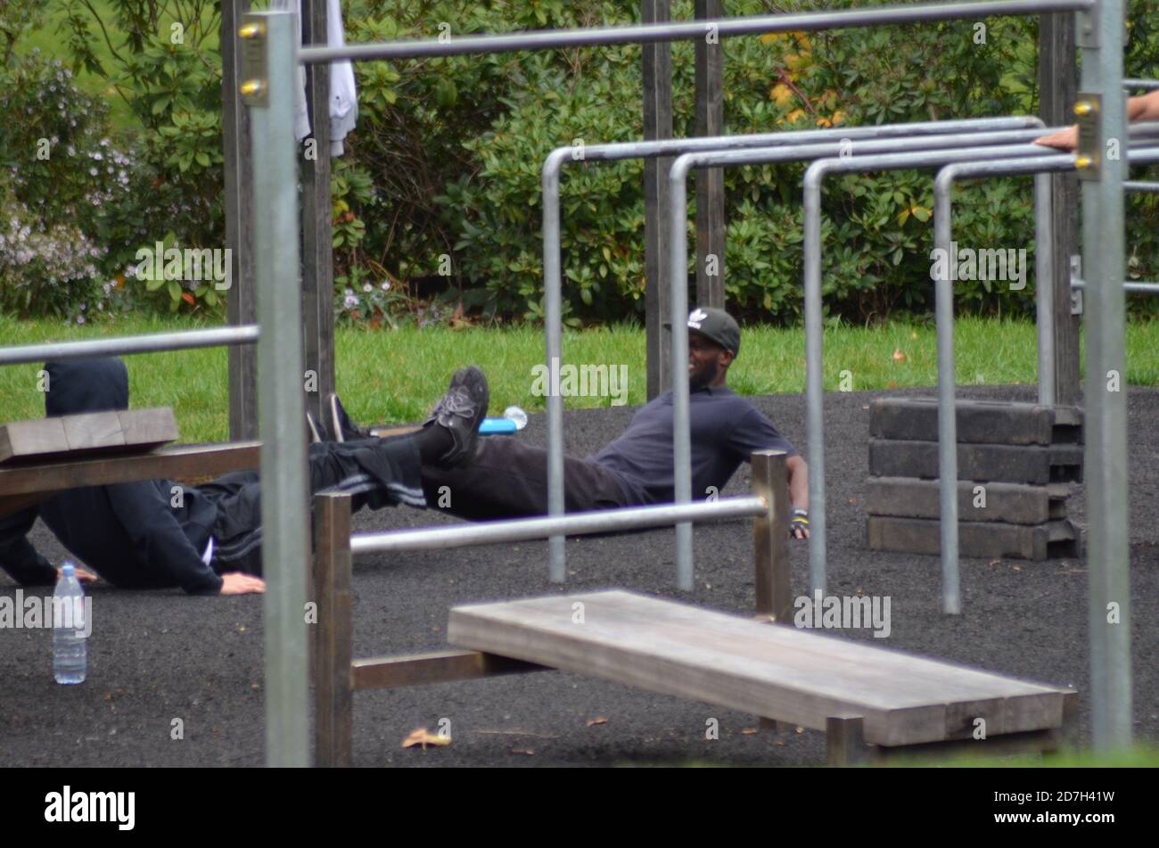 Black Fitness goers on railings Stock Photo - Alamy