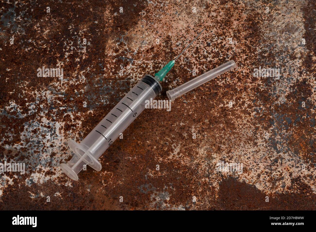 Syringe and drugs on dirty rusty background. Injection syringe