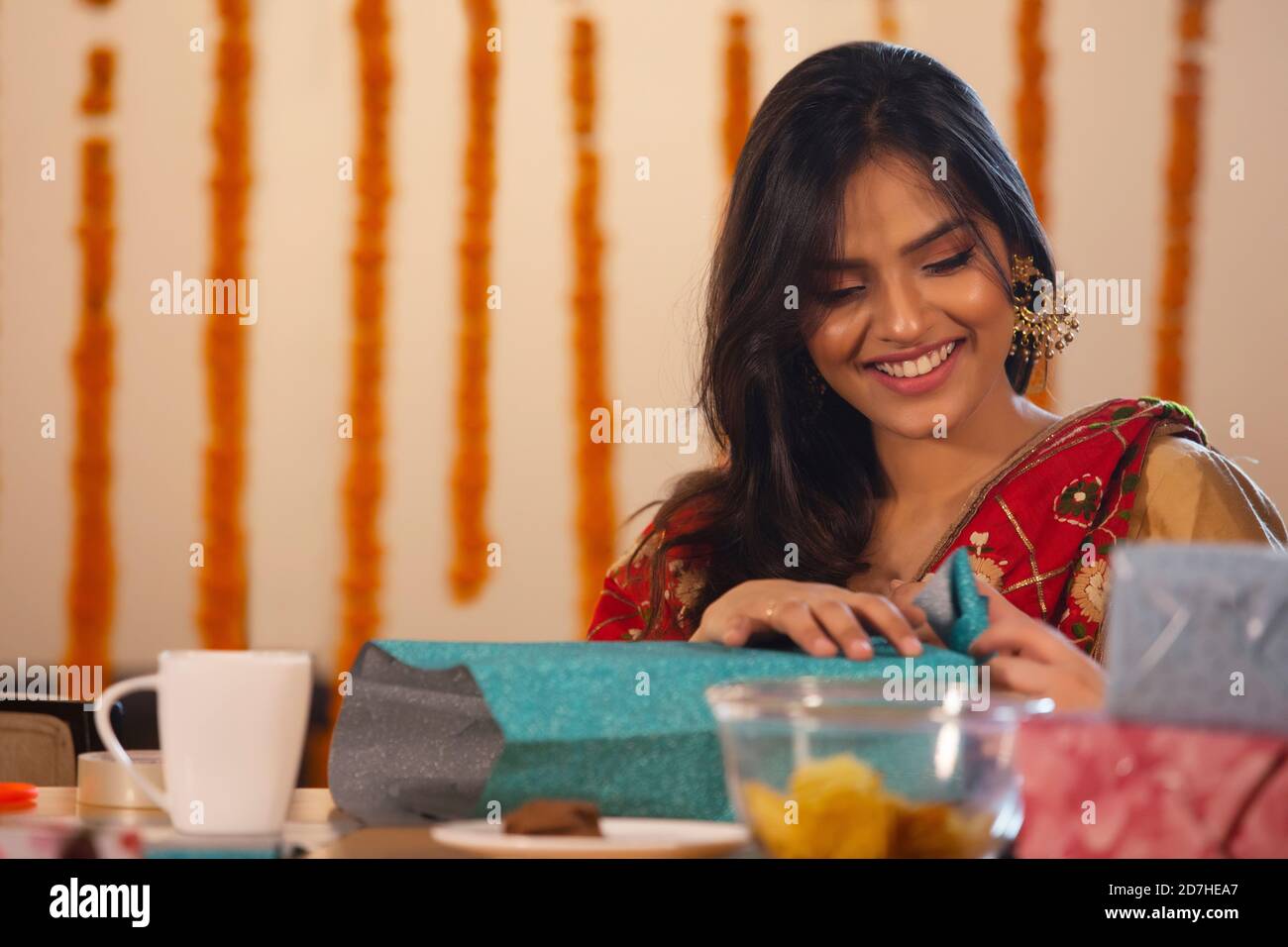 Young girl packing diwali gifts Stock Photo