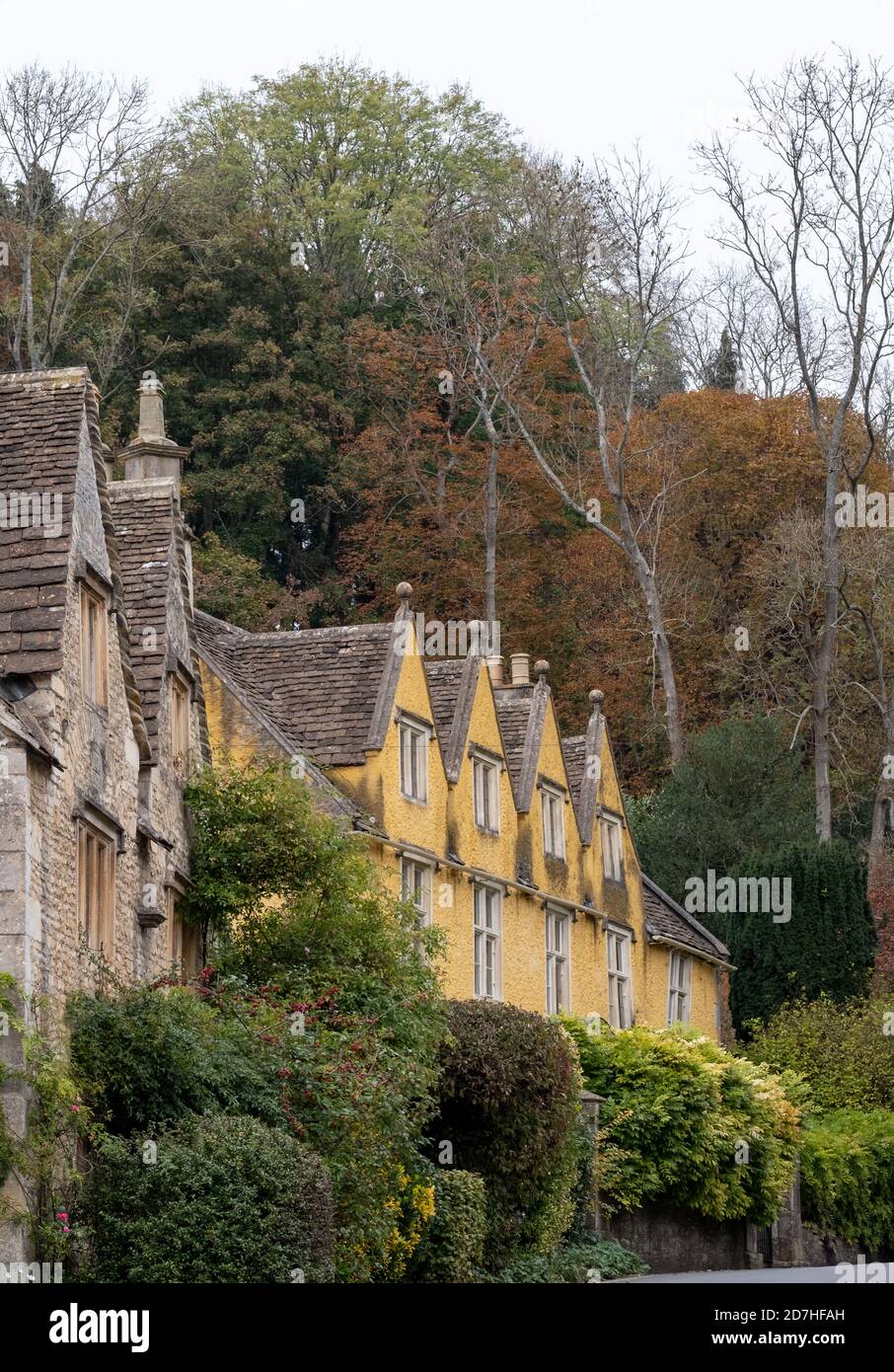 Characterful, historic houses in Castle Combe, picturesque village in Wiltshire in the Cotswolds, Gloucestershire UK. Photographed in autumn. Stock Photo