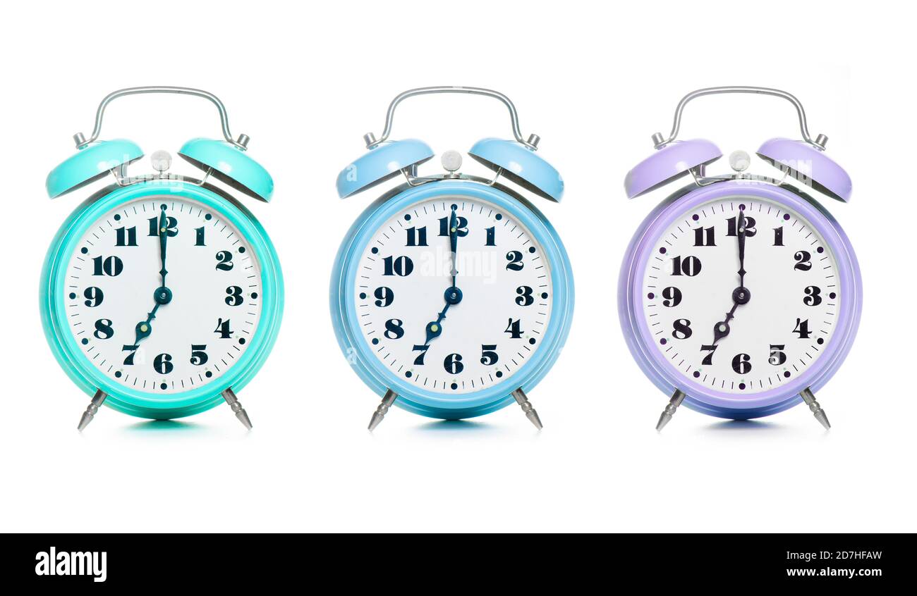 Three colorful alarm clocks on a white background Stock Photo Alamy