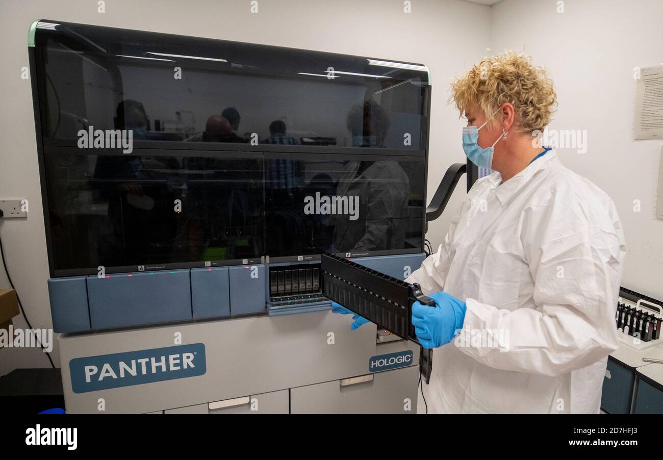 Lab Instrument Rep Covid Testing A laboratory worker places Covid-19 tests inside a diagnostics machine ...