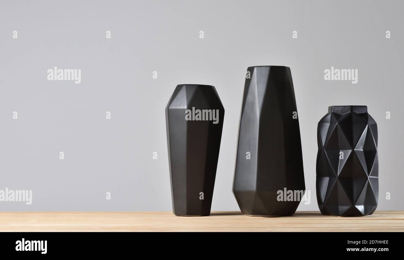 Empty modern black geometric vases on gray background Stock Photo