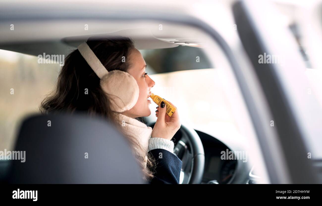 Happy young woman dressed in stylish clothes in a car. Stock Photo