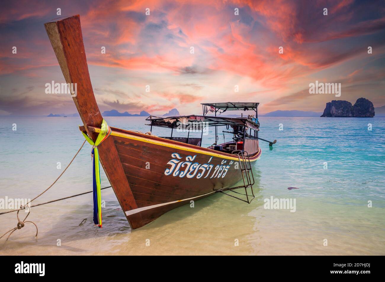 Amazing sunset over longtail boat on beach in Thailand Stock Photo