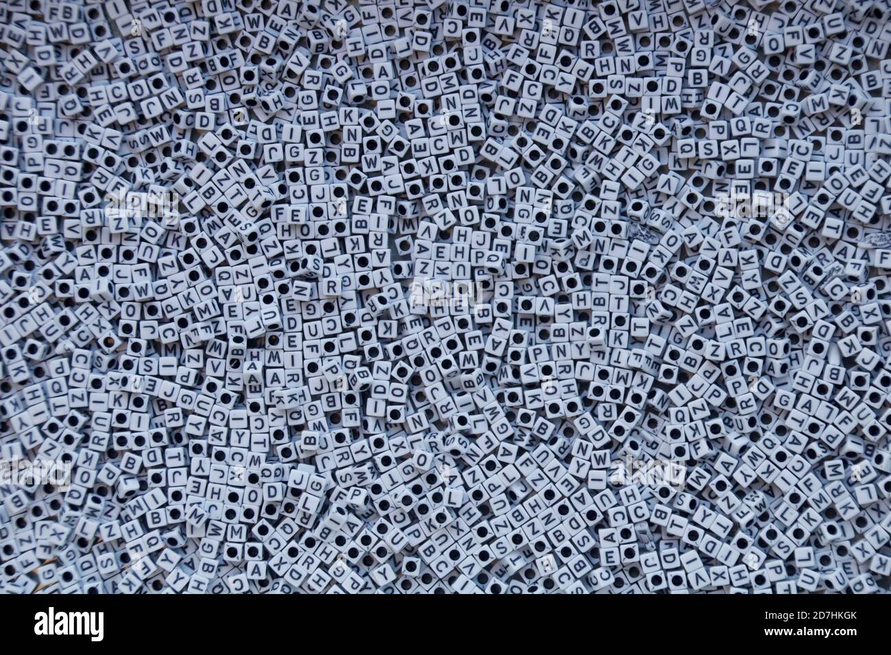 Cluster of white cube-shaped beads with black letters. Stock Photo